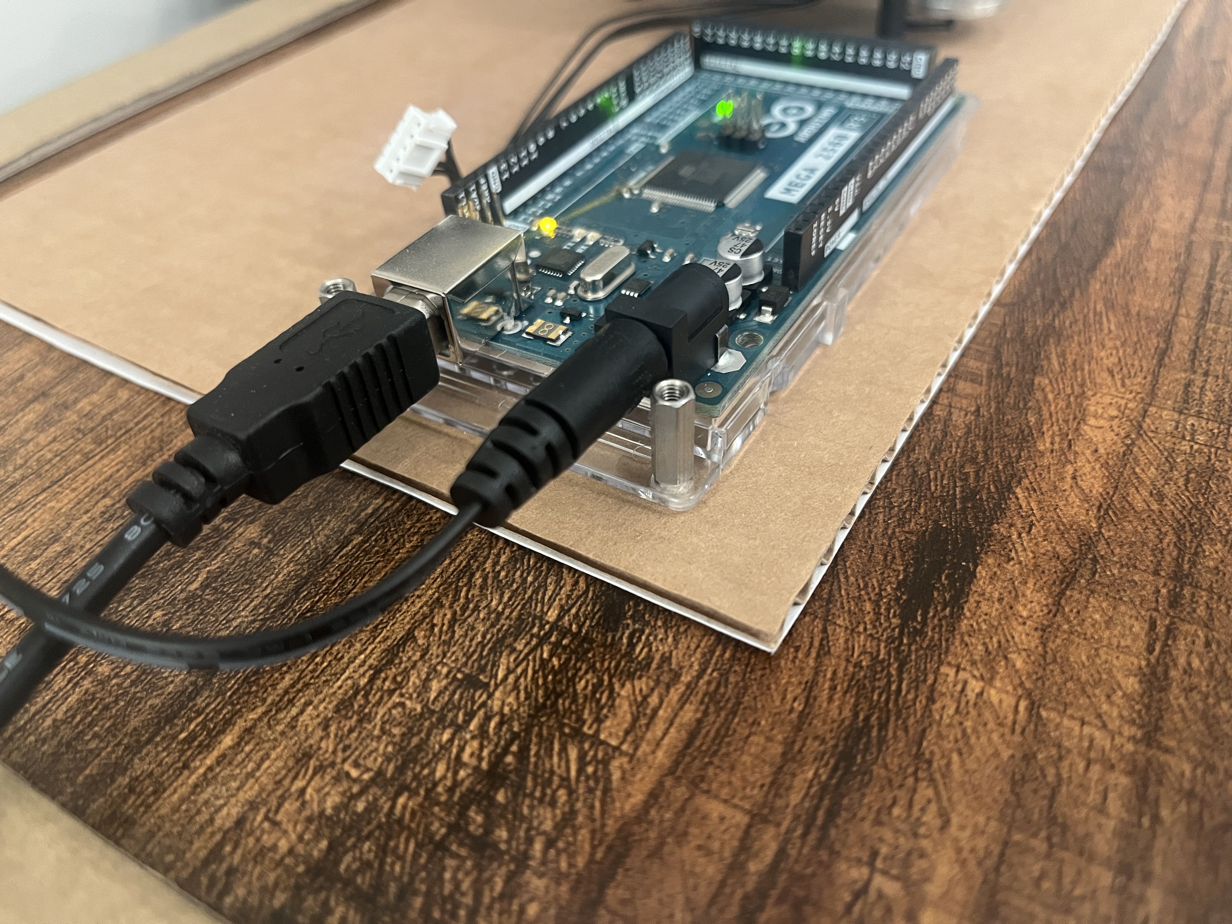 An Arduino board plugged in to power and USB
